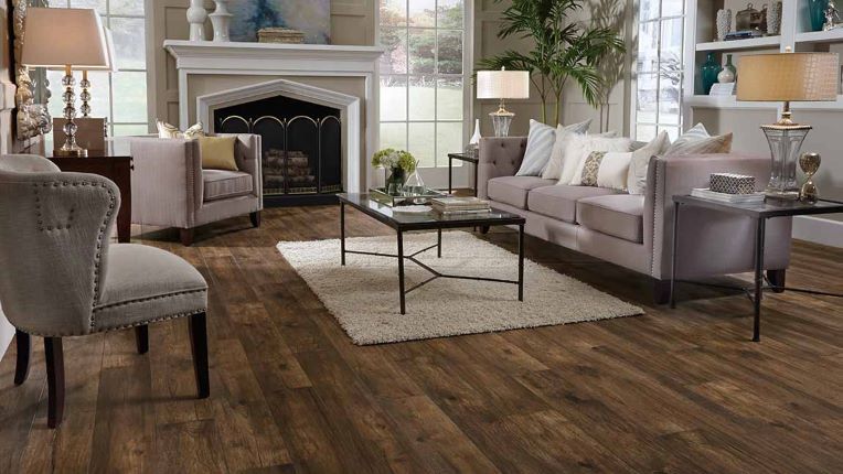 beautiful wood look laminate flooring in a traditional living room with fireplace